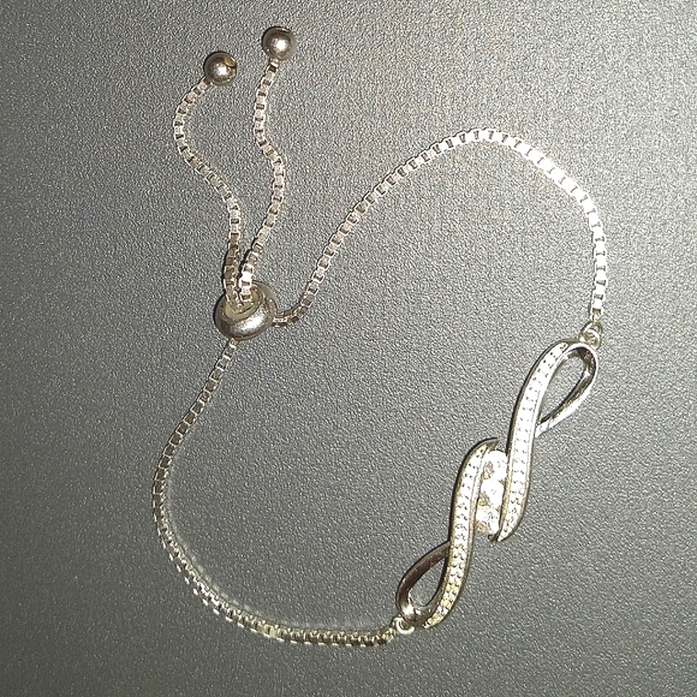 Sterling Silver Bracelet Encrusted With White Sapphires - Infinity Design